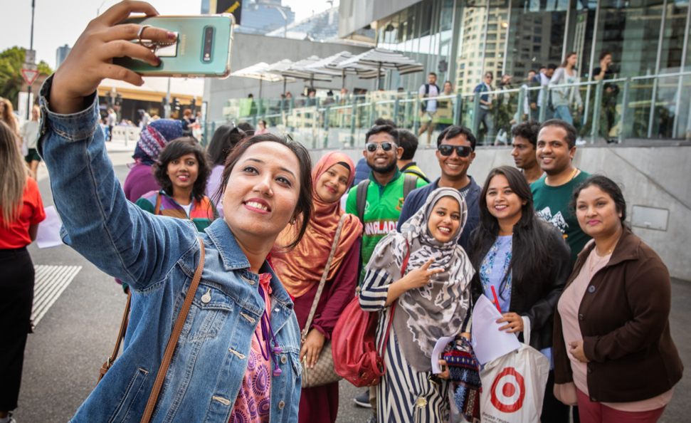 Australia Awards scholars taking a group selfie in Melbourne