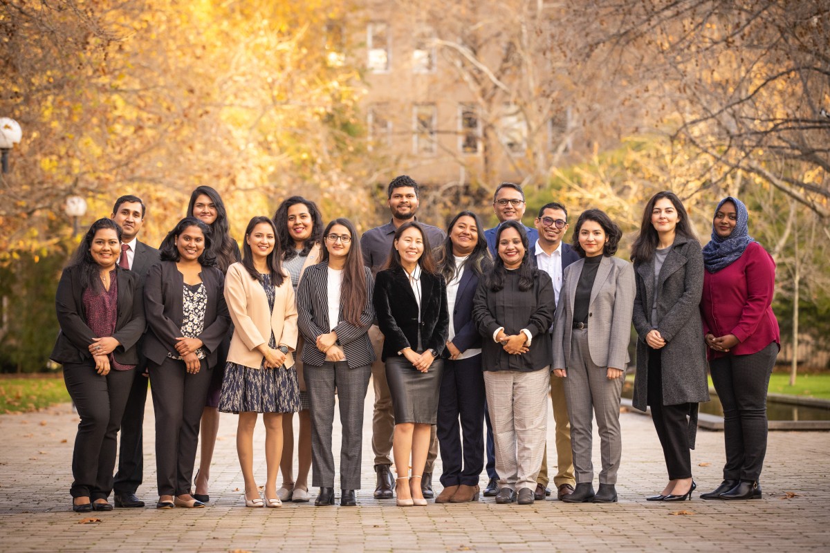 Group of Australia Awards scholars posing outdoors in autumn