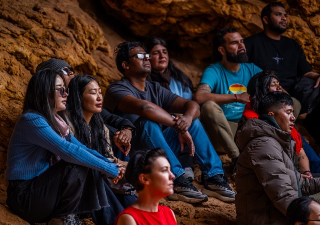 Kargen (fourth from right, back row) engaging in a reflective exercise led by guide John with other scholars and Alice Tamang (front, in red), Australia Awards – South Asia & Mongolia Indigenous Engagement Adviser.