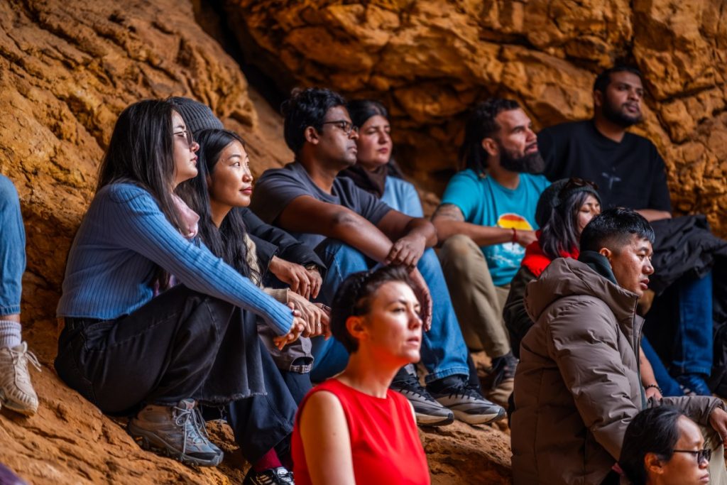 Dorji (in brown jacket) engaging in a mindfulness exercise with other scholars during the visit. 
