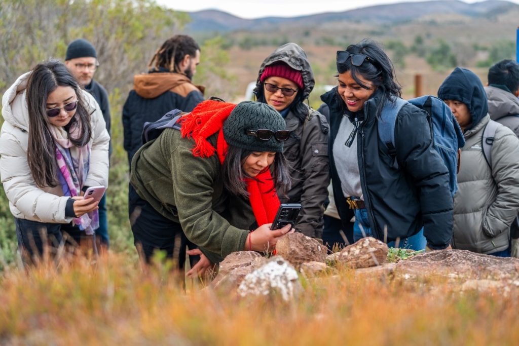 Scholar Rubine Bishunke (with red scarf) taking a picture of ... at the Ikara-Flinders Ranges National Park. 