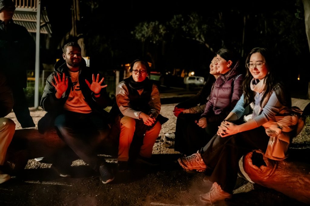Suvd-Erdene (right) having a light-hearted moment with other scholars after engaging in the fire-making exercise.