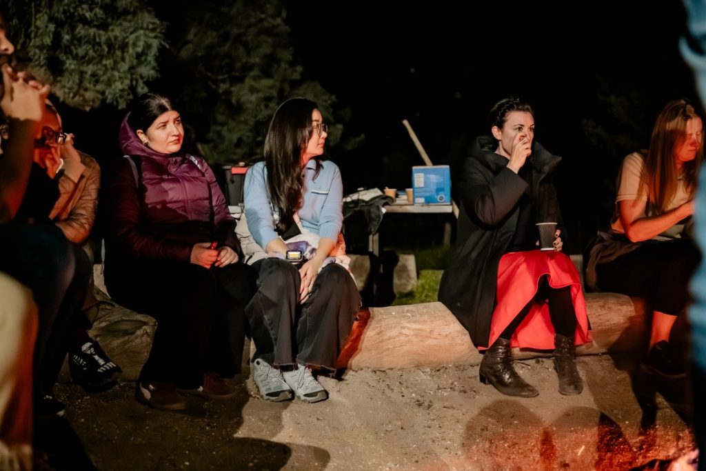 Shamsa listening to ... after engaging in a fire-making exercise. 