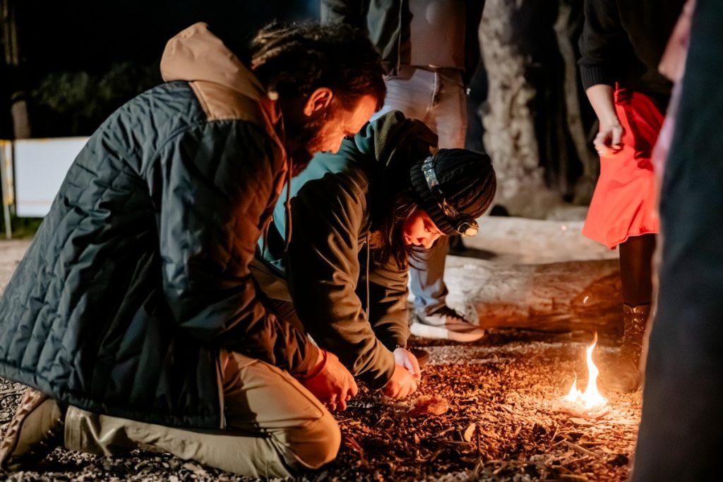Scholar Rubina Bishunke making a fire under the guidance of John (right).