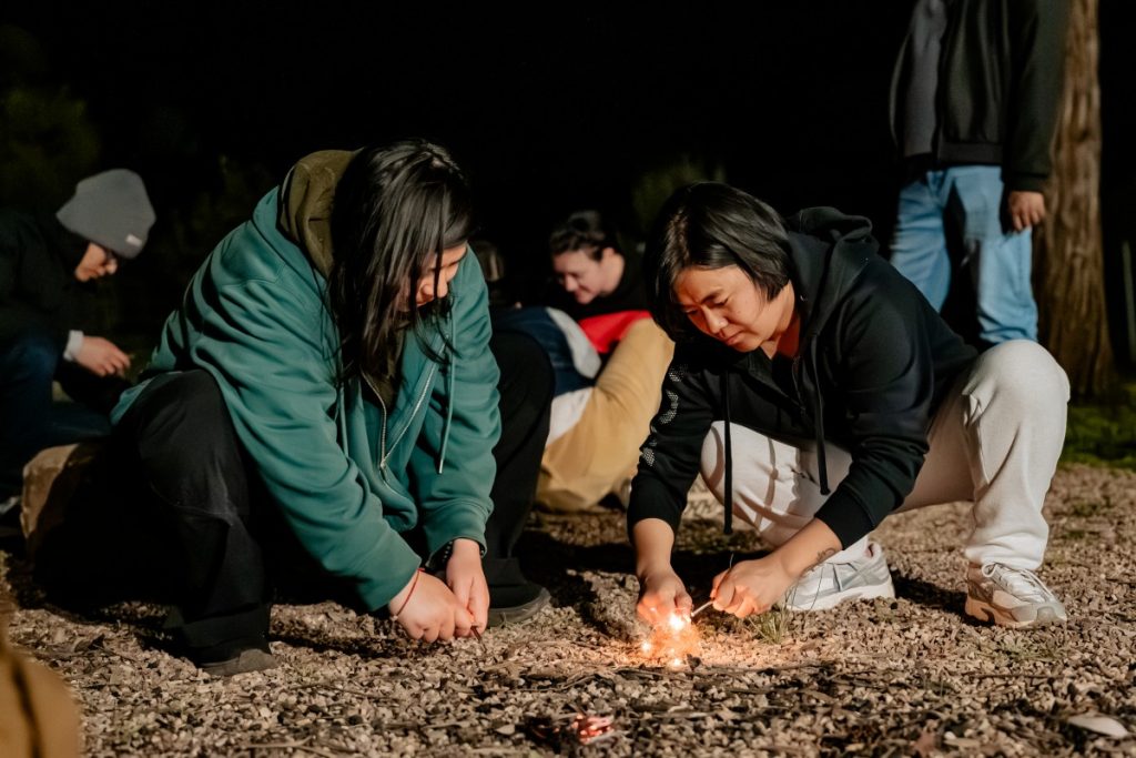 Nepali scholar Rita Baramu (right) engaged in a fire-making exercise with fellow Nepali scholar Rubina Bishunke.