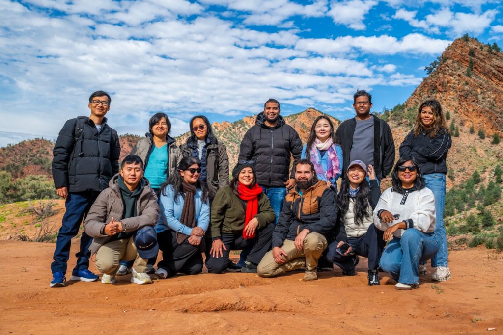 Aki (left, back row) photographed with other scholars and guide John during the visit.