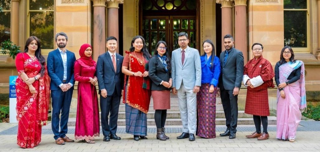 2026–2027 Scholar Ambassadors standing outside a university building